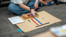 teacher teaching math using colored tiles