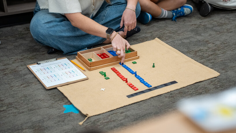 teacher teaching math using colored tiles